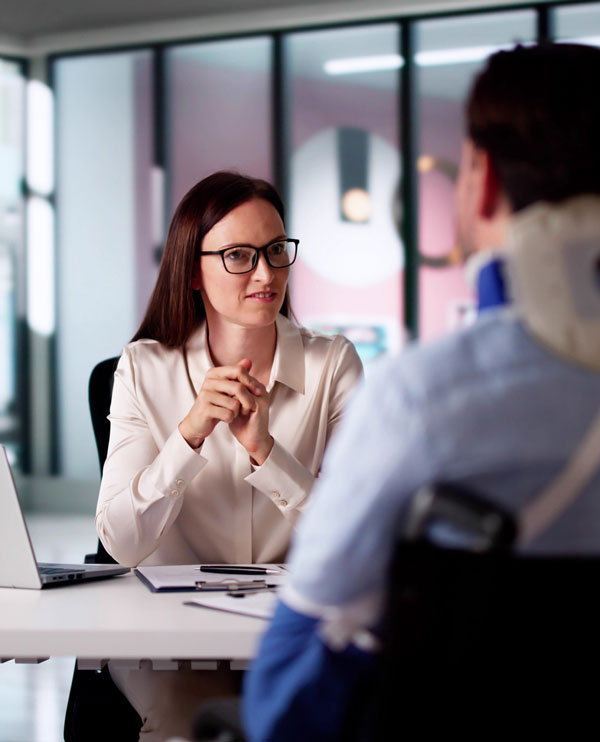 Injury lawyer speaking with a client.